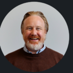 Smiling bearded man in brown sweater