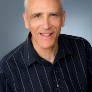 Smiling man in dark striped shirt